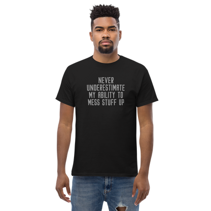 "Never Understimate My Ability To Mess Stuff Up" printed on a black unisex classic tee worn by a male
