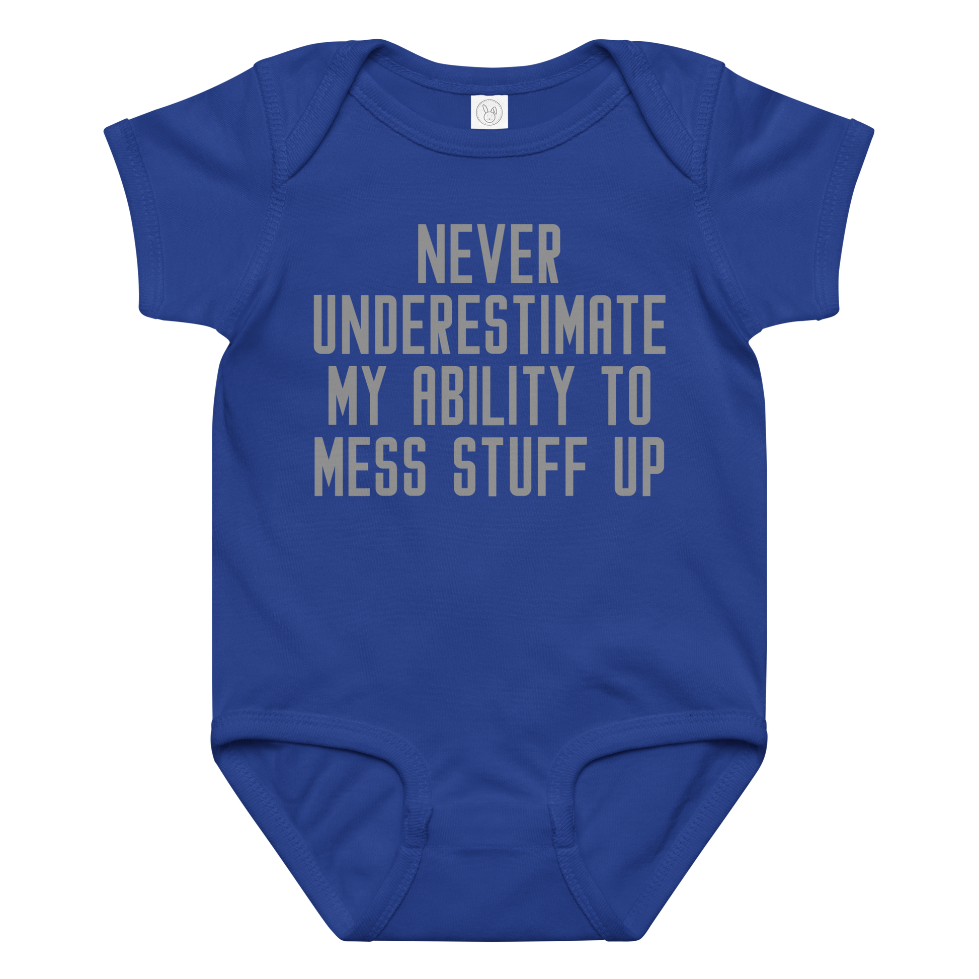 "Never Understimate My Ability To Mess Stuff Up" printed on a royal baby jersey bodysuit laying on a flat surface amongst other clothes
