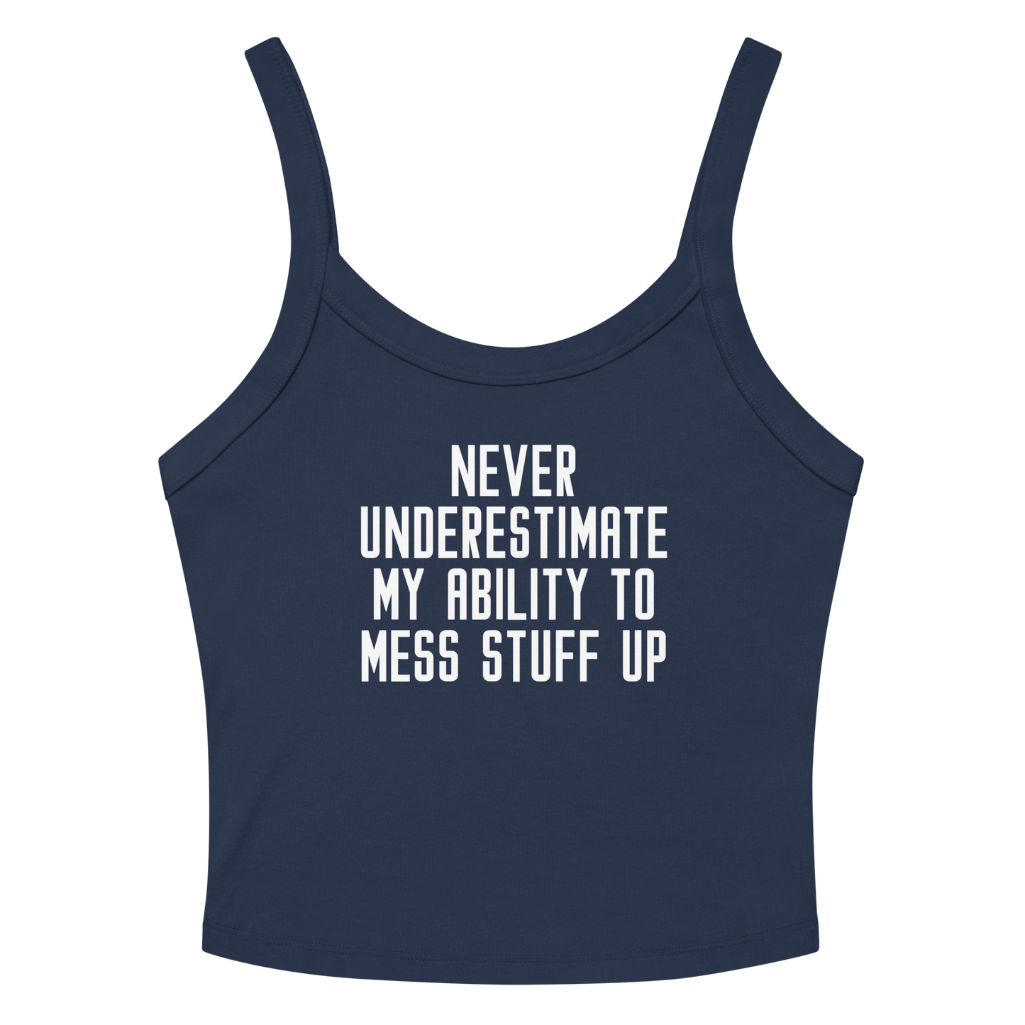 "Never Understimate My Ability To Mess Stuff Up" printed on a solid navy blend women's micro-rib tanktop laying on a flat surface amongst sunglasses and shorts