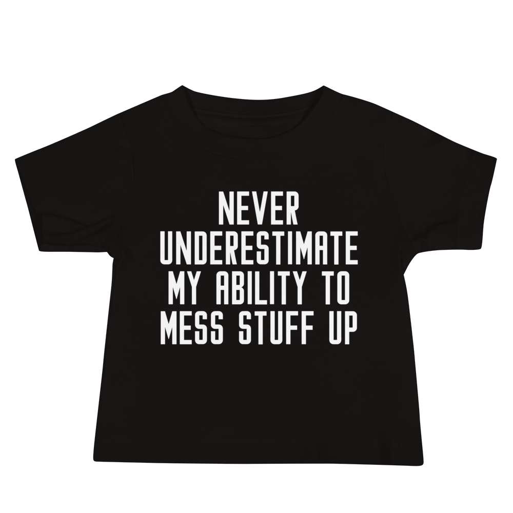"Never Understimate My Ability To Mess Stuff Up" printed on a black baby jersey short sleeve tee laying on a flat surface