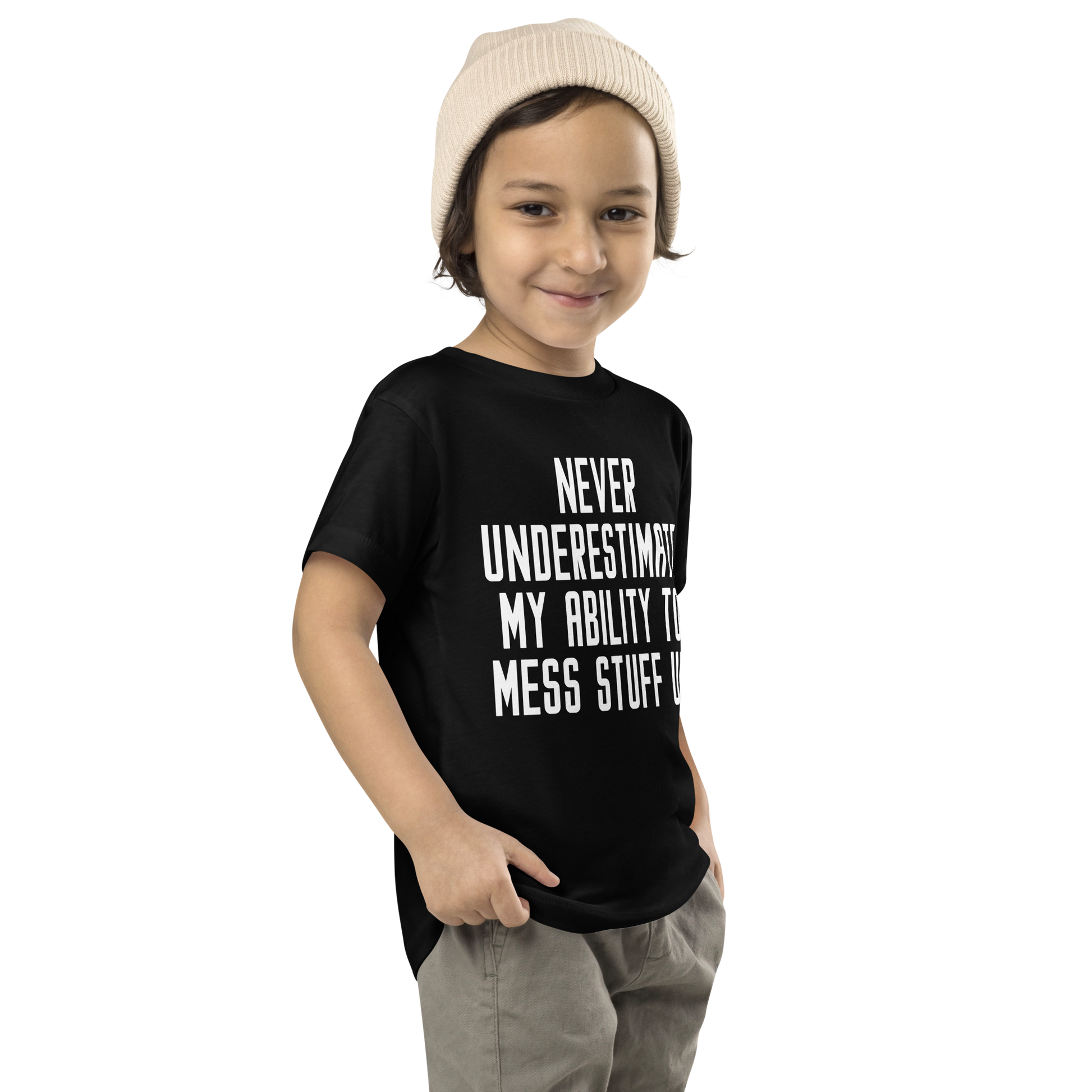 "Never Understimate My Ability To Mess Stuff Up" printed on a black toddler short sleeve tee worn by a male who is also wearing a knit cap