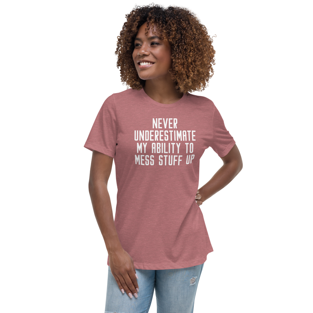 "Never Understimate My Ability To Mess Stuff Up" printed on a heather mauve women's relaxed t-shirt worn by a female