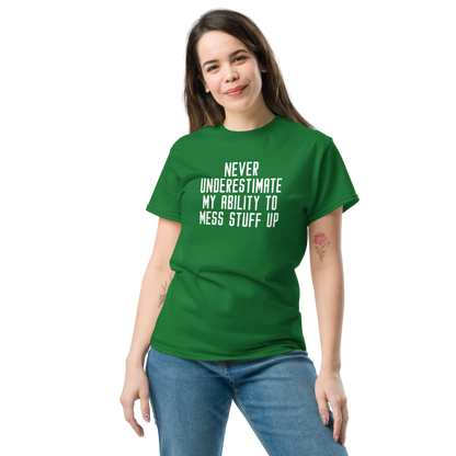 "Never Understimate My Ability To Mess Stuff Up" printed on a turf green unisex classic tee worn by a female