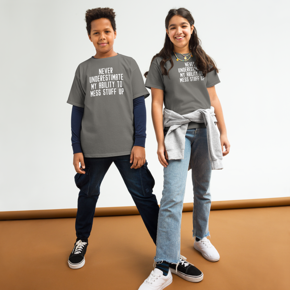 "Never Understimate My Ability To Mess Stuff Up" printed on a charcoal youth classic tee worn by a female and male