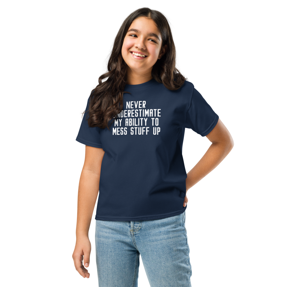"Never Understimate My Ability To Mess Stuff Up" printed on a navy youth classic tee worn by a female