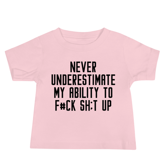"Never Understimate My Ability To F#Ck Sh:t Up" printed on a pink baby jersey short sleeve tee laying on a flat surface