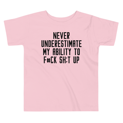 "Never Understimate My Ability To F#Ck Sh:t Up" printed on a pink toddler short sleeve tee laying on a flat surface