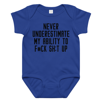 "Never Understimate My Ability To F#Ck Sh:t Up" printed on a royal baby jersey bodysuit laying on a flat surface amongst other clothes