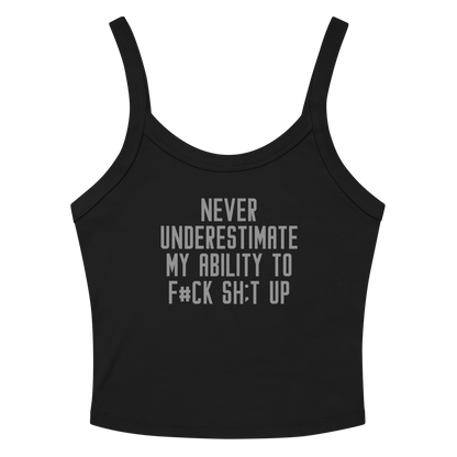 "Never Understimate My Ability To F#Ck Sh:t Up" printed on a solid black blend women's micro-rib tanktop laying on a flat surface amongst sunglasses and shorts