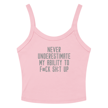 "Never Understimate My Ability To F#Ck Sh:t Up" printed on a solid pink blend women's micro-rib tanktop laying on a flat surface amongst sunglasses and shorts