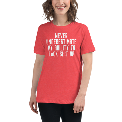 "Never Understimate My Ability To F#Ck Sh:t Up" printed on a heather red women's relaxed t-shirt worn by a female