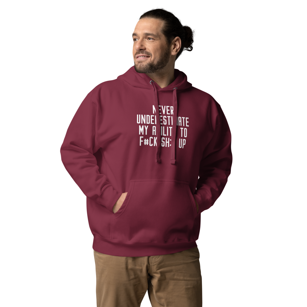 "Never Understimate My Ability To F#Ck Sh:t Up" printed on a maroon unisex hoodie worn by a male