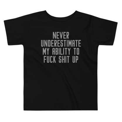 "Never Understimate My Ability To Fuck Shit Up" printed on a black toddler short sleeve tee laying on a flat surface