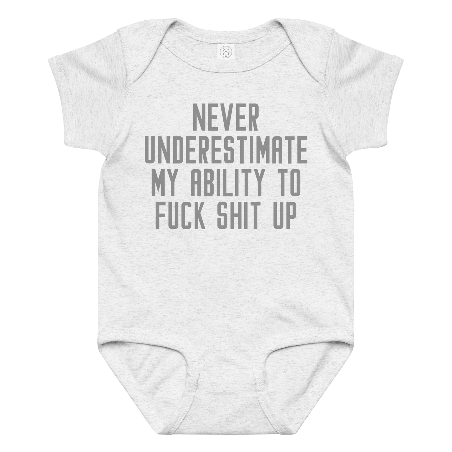 "Never Understimate My Ability To Fuck Shit Up" printed on a ash baby jersey bodysuit laying on a flat surface amongst other clothes
