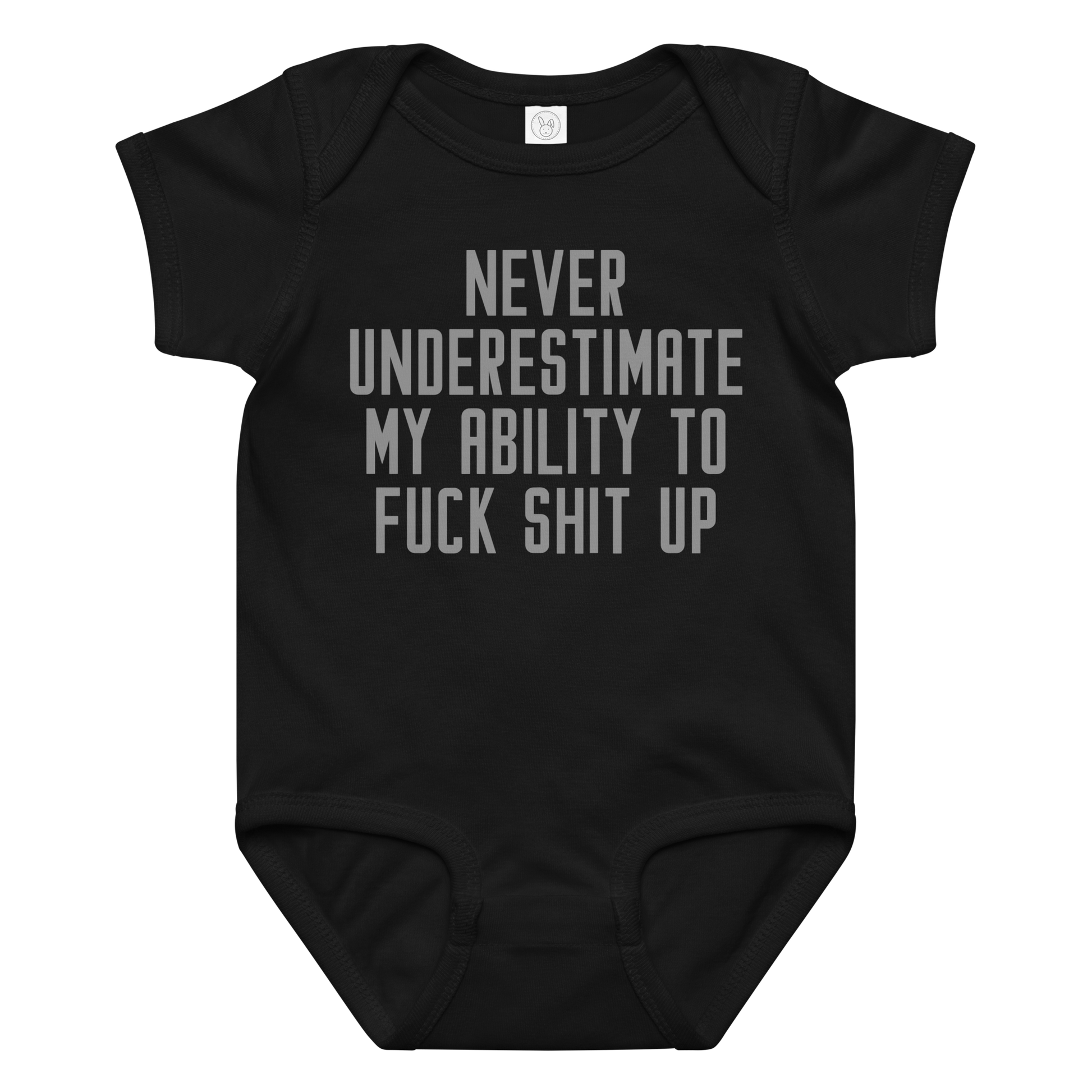 "Never Understimate My Ability To Fuck Shit Up" printed on a black baby jersey bodysuit laying on a flat surface amongst other clothes