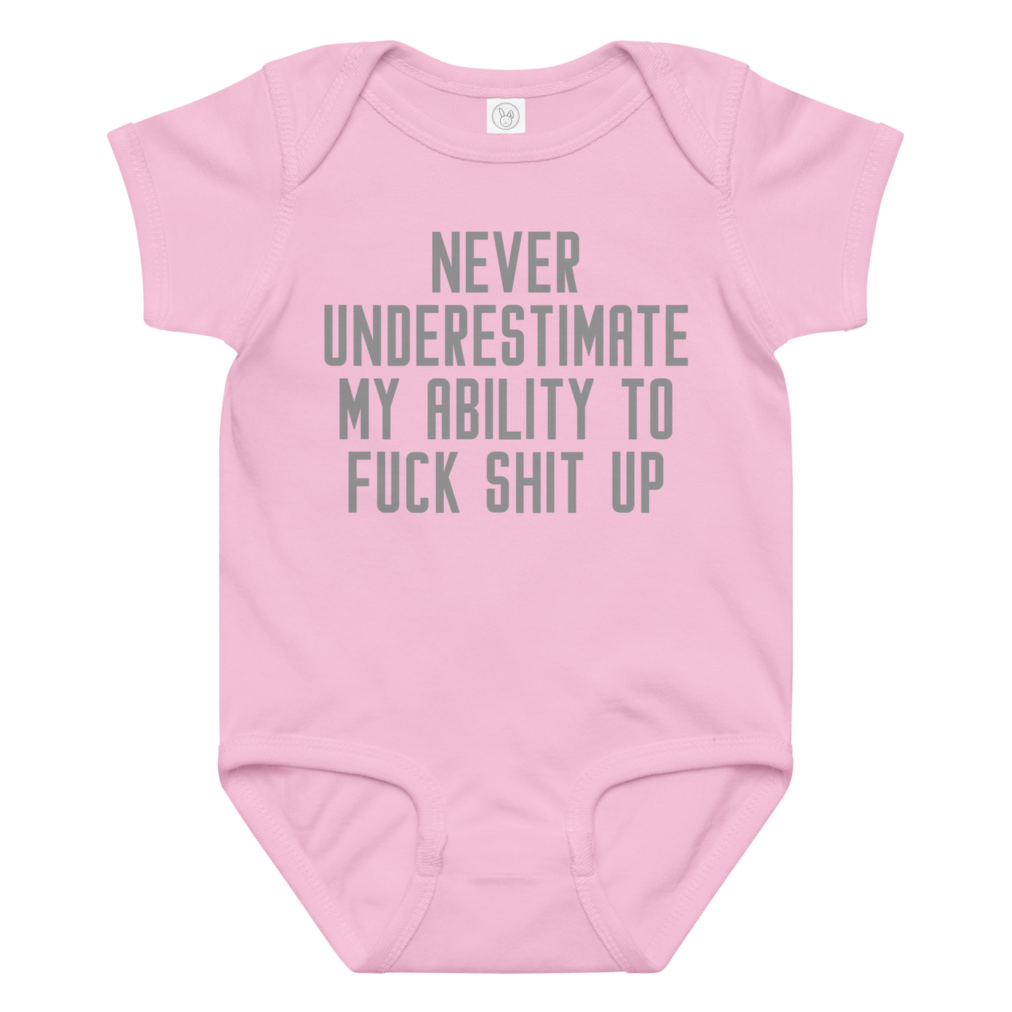 "Never Understimate My Ability To Fuck Shit Up" printed on a pink baby jersey bodysuit laying on a flat surface amongst other clothes