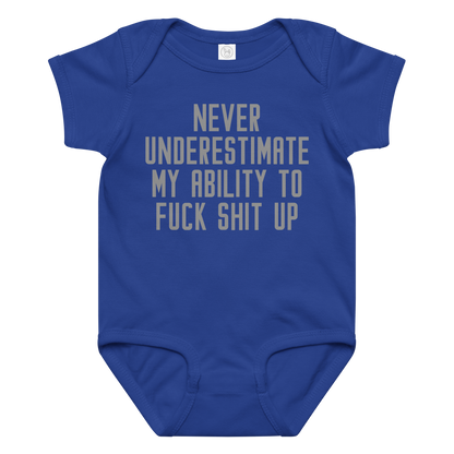 "Never Understimate My Ability To Fuck Shit Up" printed on a royal baby jersey bodysuit laying on a flat surface amongst other clothes