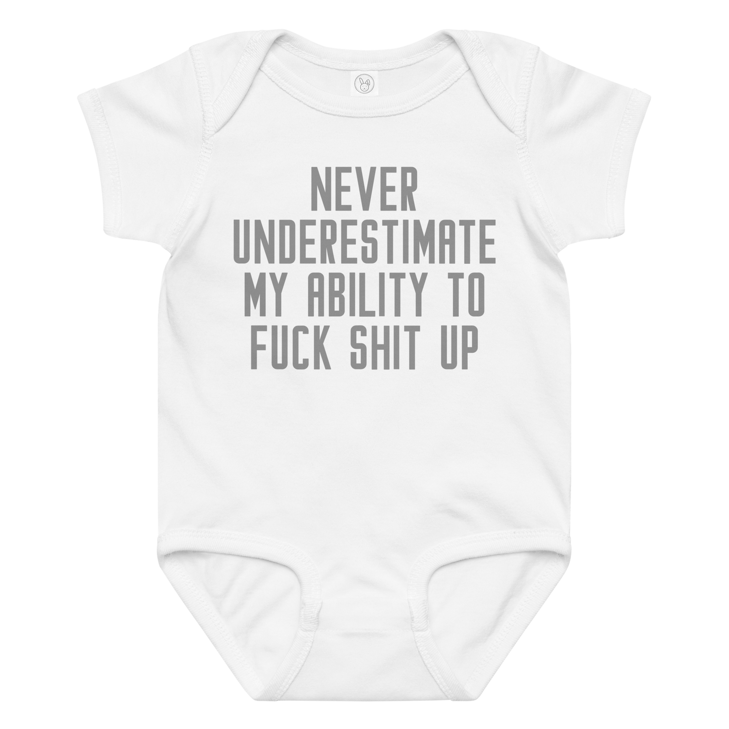 "Never Understimate My Ability To Fuck Shit Up" printed on a white baby jersey bodysuit laying on a flat surface amongst other clothes