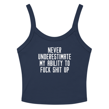 "Never Understimate My Ability To Fuck Shit Up" printed on a solid navy blend women's micro-rib tanktop laying on a flat surface amongst sunglasses and shorts