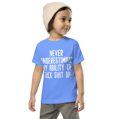 "Never Understimate My Ability To Fuck Shit Up" printed on a heather columbia blue toddler short sleeve tee worn by a male wearing a cap