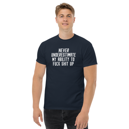 "Never Understimate My Ability To Fuck Shit Up" printed on a navy unisex classic tee worn by a male