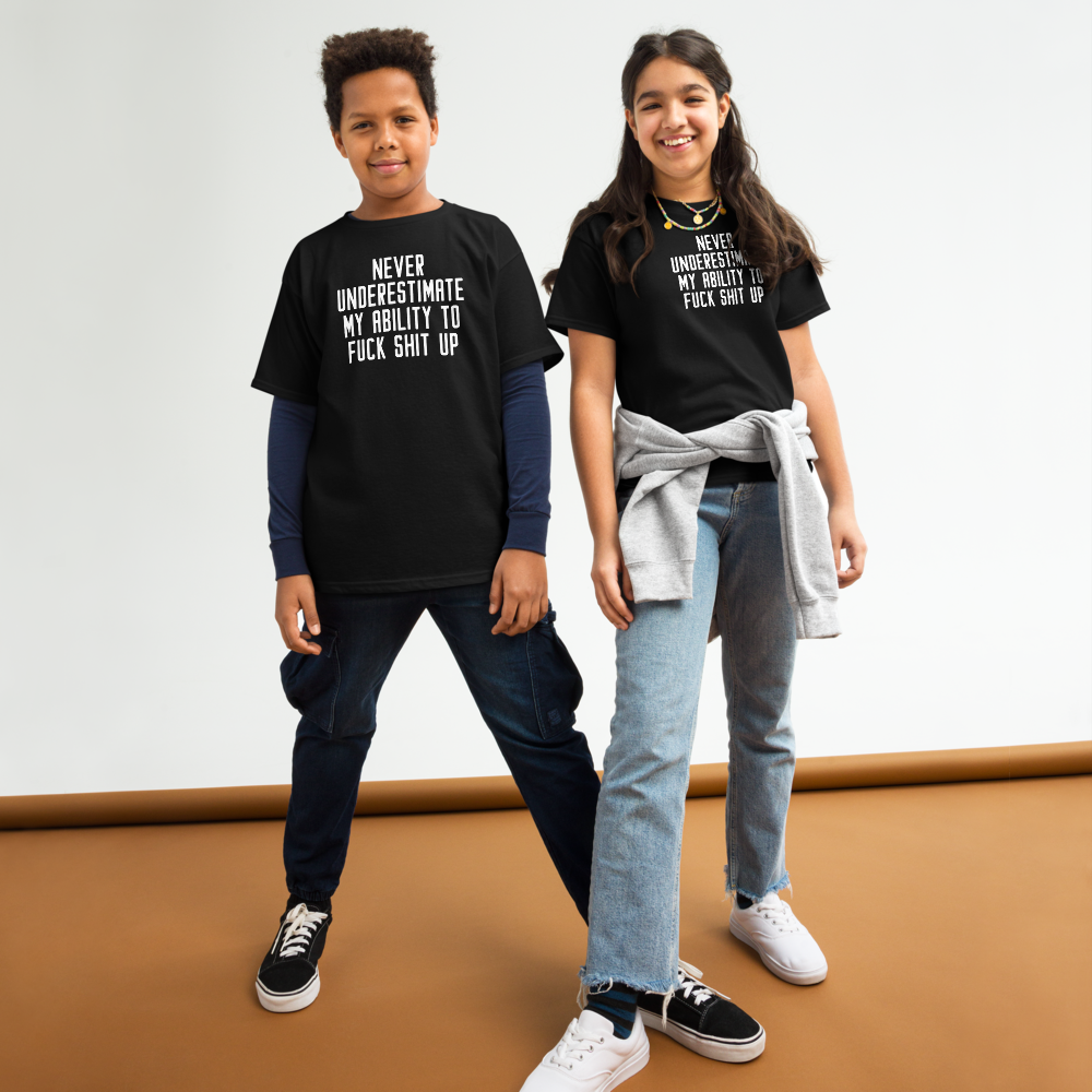 "Never Understimate My Ability To Fuck Shit Up" printed on a black youth classic tee worn by a female and male