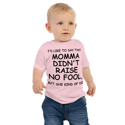 "I'd like to say that momma didn't raise no fool, but she kind of did" printed on a pink baby jersey short sleeve tee worn by a male