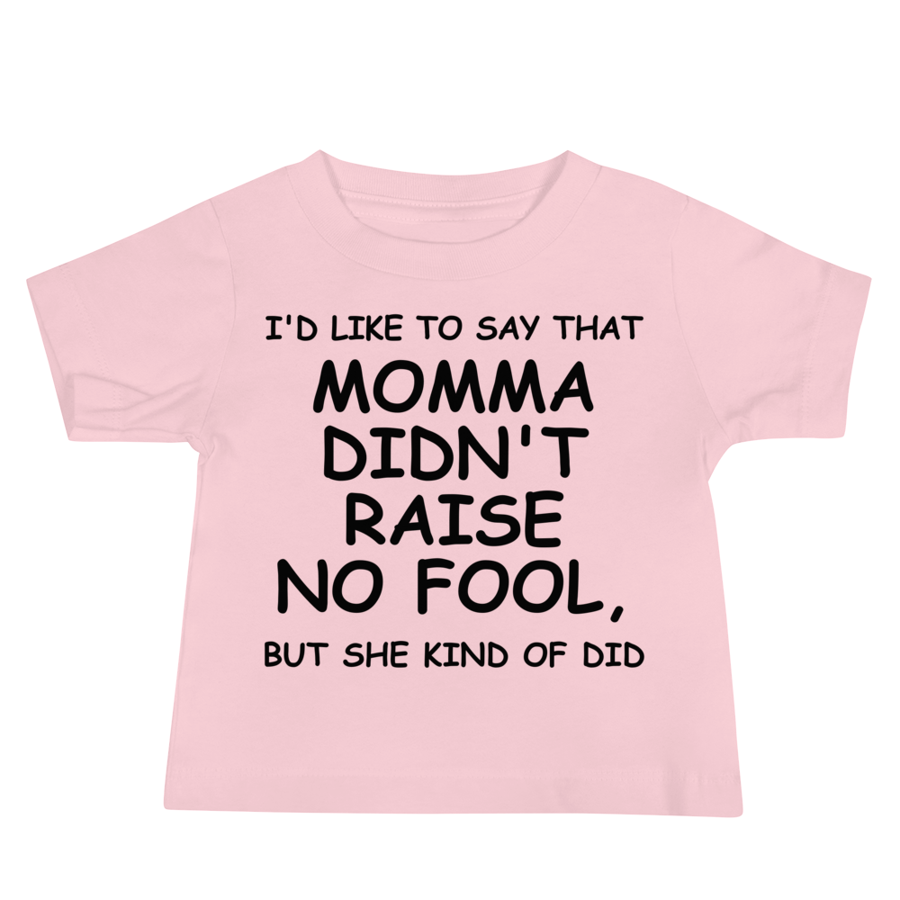 "I'd like to say that momma didn't raise no fool, but she kind of did" printed on a pink baby jersey short sleeve tee laying on a flat surface
