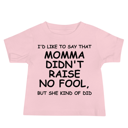 "I'd like to say that momma didn't raise no fool, but she kind of did" printed on a pink baby jersey short sleeve tee laying on a flat surface