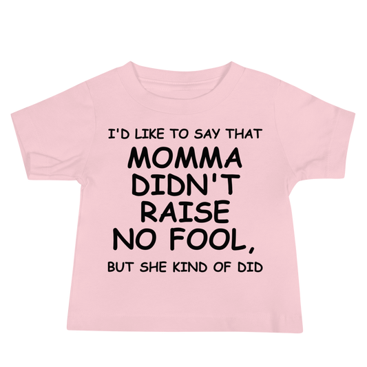 "I'd like to say that momma didn't raise no fool, but she kind of did" printed on a pink baby jersey short sleeve tee laying on a flat surface