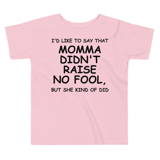 "I'd like to say that momma didn't raise no fool, but she kind of did" printed on a pink toddler short sleeve tee laying on a flat surface