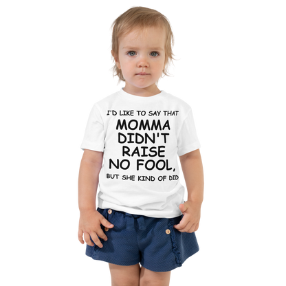 "I'd like to say that momma didn't raise no fool, but she kind of did" printed on a white toddler short sleeve tee worn by a female