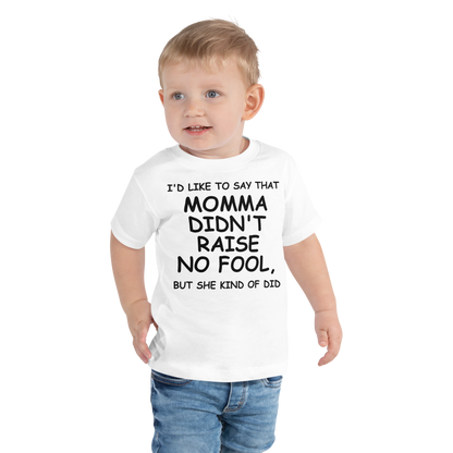 "I'd like to say that momma didn't raise no fool, but she kind of did" printed on a white toddler short sleeve tee worn by a male