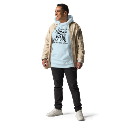 "I'd like to say that momma didn't raise no fool, but she kind of did" printed on a sky blue unisex hoodie worn by a male with a jacket on top