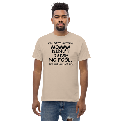 "I'd like to say that momma didn't raise no fool, but she kind of did" printed on a sand unisex classic tee worn by a male