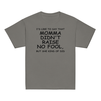 "I'd like to say that momma didn't raise no fool, but she kind of did" printed on a charcoal youth classic tee laying on a flat surface