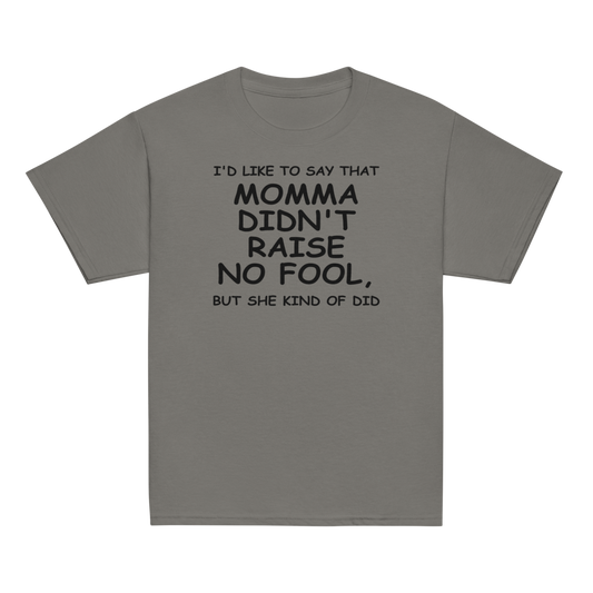 "I'd like to say that momma didn't raise no fool, but she kind of did" printed on a charcoal youth classic tee laying on a flat surface