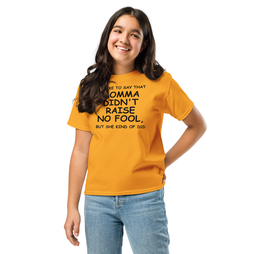 "I'd like to say that momma didn't raise no fool, but she kind of did" printed on a gold youth classic tee worn by a female