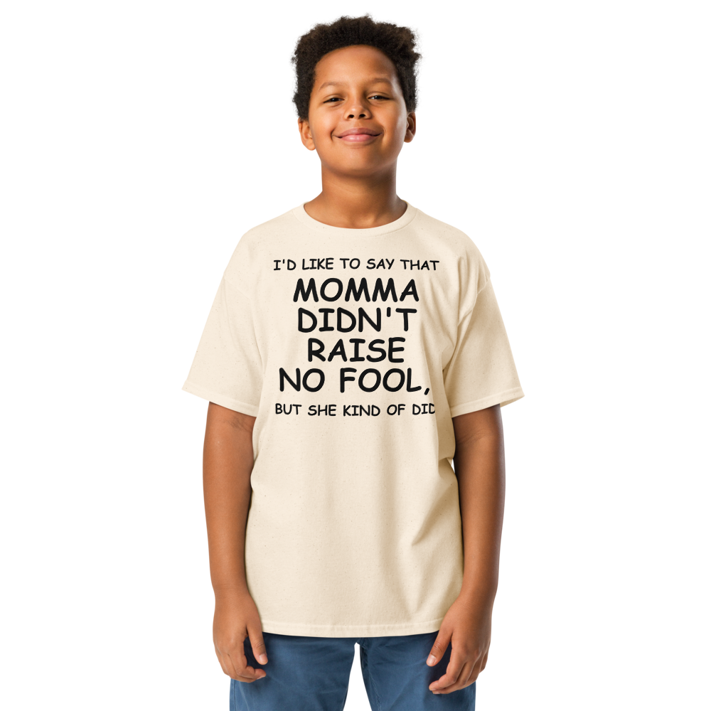 "I'd like to say that momma didn't raise no fool, but she kind of did" printed on a natural youth classic tee worn by a male