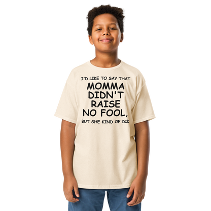"I'd like to say that momma didn't raise no fool, but she kind of did" printed on a natural youth classic tee worn by a male