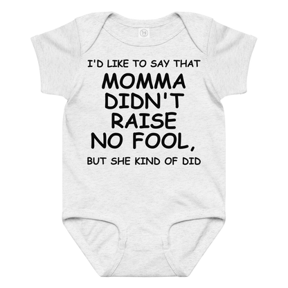 "I'd like to say that momma didn't raise no fool, but she kind of did" printed on a ash baby jersey bodysuit laying on a flat surface amongst other clothes