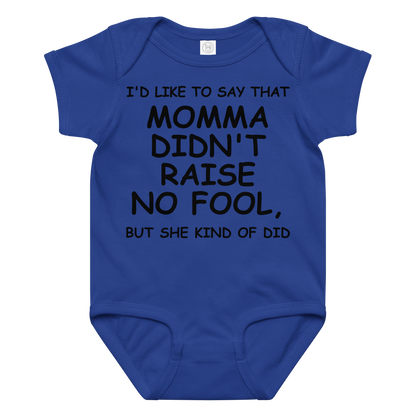 "I'd like to say that momma didn't raise no fool, but she kind of did" printed on a royal baby jersey bodysuit laying on a flat surface amongst other clothes