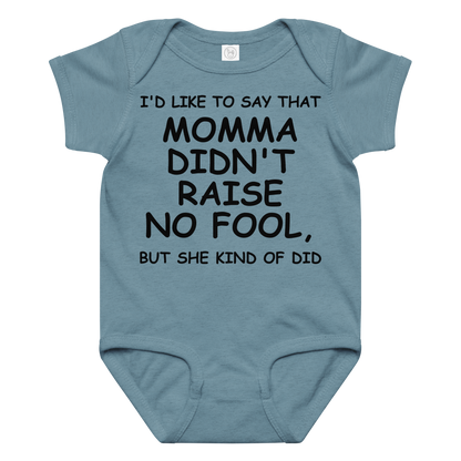 "I'd like to say that momma didn't raise no fool, but she kind of did" printed on a vintage indigo baby jersey bodysuit laying on a flat surface amongst other clothes