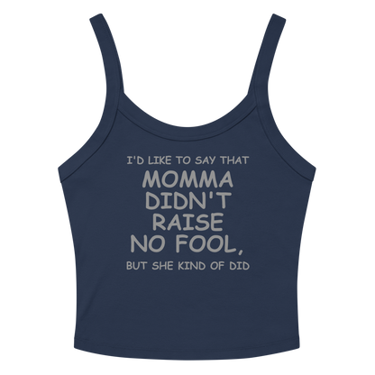 "I'd like to say that momma didn't raise no fool, but she kind of did" printed on a solid navy blend women's micro-rib tanktop laying on a flat surface amongst sunglasses and shorts