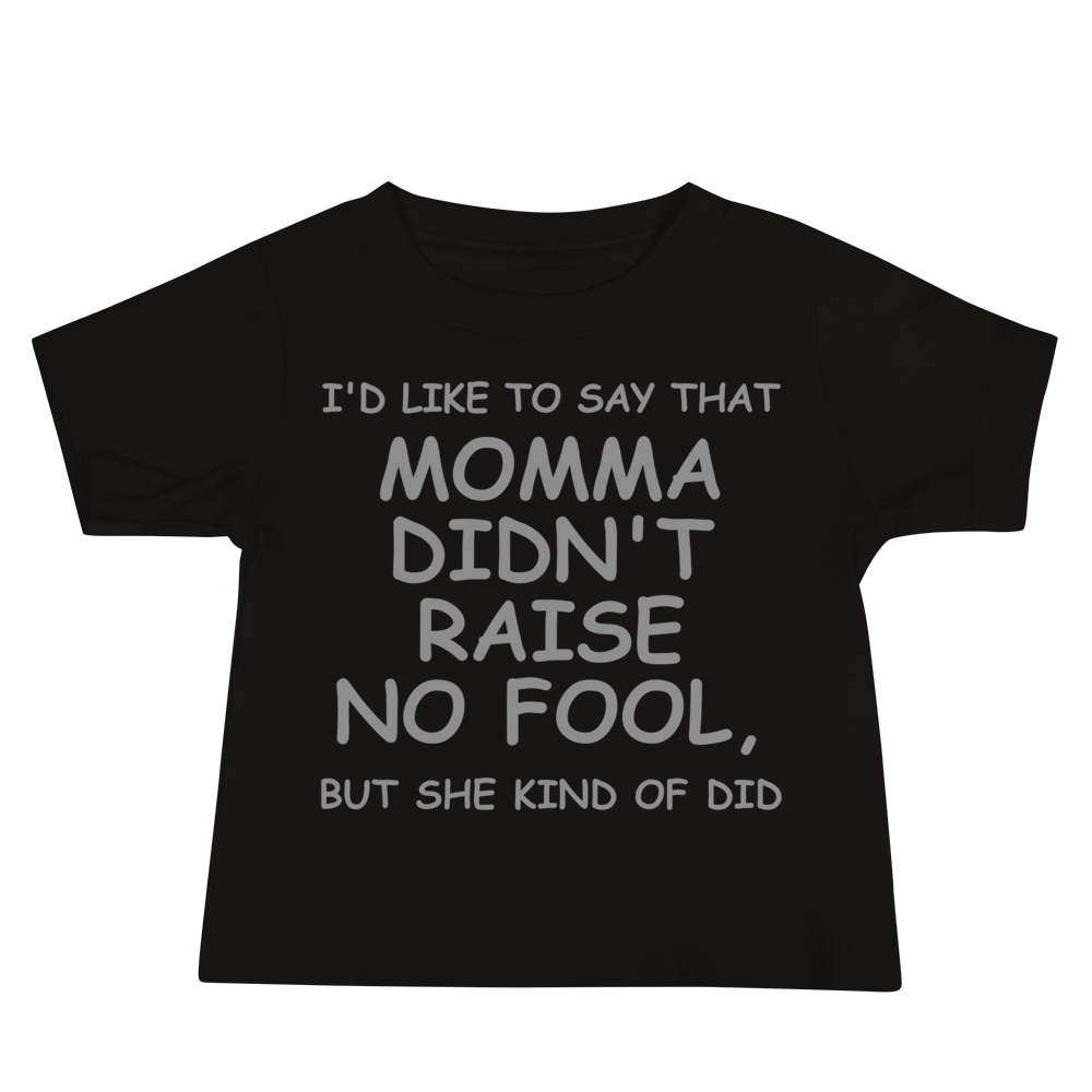 "I'd like to say that momma didn't raise no fool, but she kind of did" printed on a black baby jersey short sleeve tee laying on a flat surface