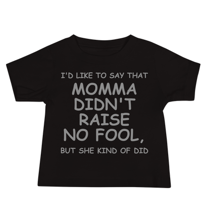 "I'd like to say that momma didn't raise no fool, but she kind of did" printed on a black baby jersey short sleeve tee laying on a flat surface