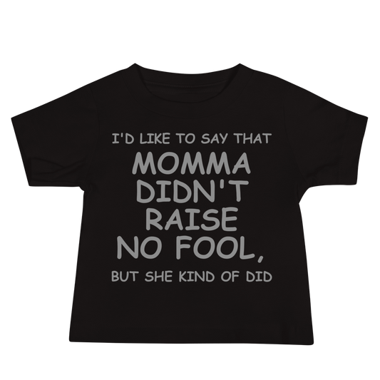 "I'd like to say that momma didn't raise no fool, but she kind of did" printed on a black baby jersey short sleeve tee laying on a flat surface