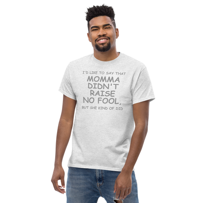 "I'd like to say that momma didn't raise no fool, but she kind of did" printed on a ash unisex classic tee worn by a male