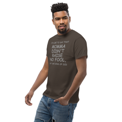"I'd like to say that momma didn't raise no fool, but she kind of did" printed on a dark chocolate unisex classic tee worn by a male