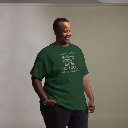 "I'd like to say that momma didn't raise no fool, but she kind of did" printed on a forest green unisex classic tee worn by a male